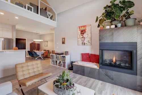 403-1441 23 Avenue Sw, Calgary, AB - Indoor Photo Showing Living Room With Fireplace