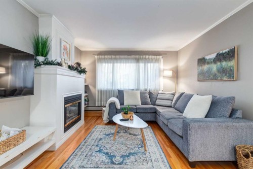 105-230 21 Avenue Sw, Calgary, AB - Indoor Photo Showing Living Room With Fireplace