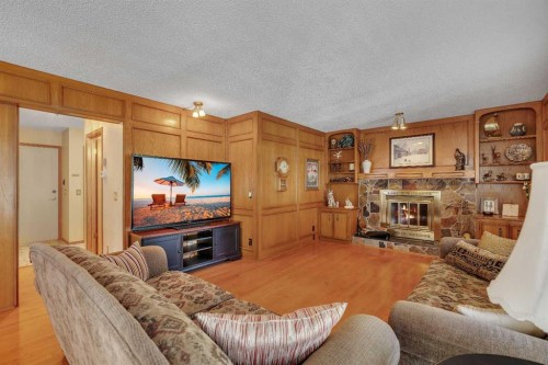 223 Shawnee Mews Sw, Calgary, AB - Indoor Photo Showing Living Room With Fireplace