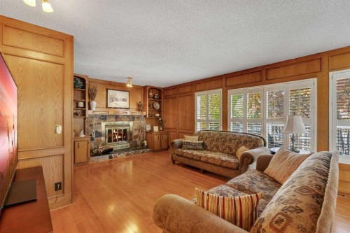 223 Shawnee Mews Sw, Calgary, AB - Indoor Photo Showing Living Room With Fireplace