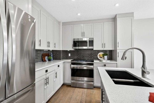 21-102 Canoe Square Sw, Airdrie, AB - Indoor Photo Showing Kitchen With Stainless Steel Kitchen With Double Sink With Upgraded Kitchen