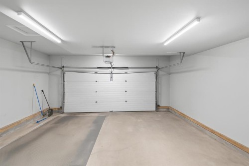 21-102 Canoe Square Sw, Airdrie, AB - Indoor Photo Showing Garage
