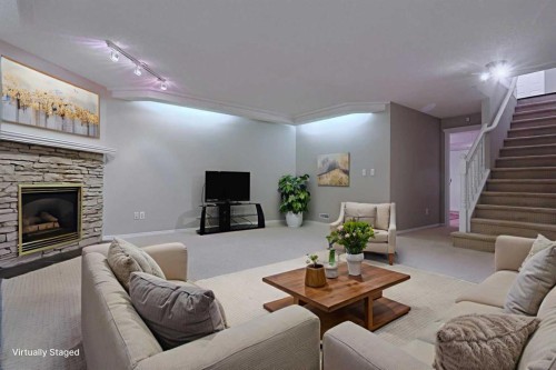 220 Silver Creek Mews Nw, Calgary, AB - Indoor Photo Showing Living Room With Fireplace