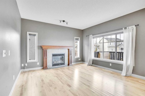 208 Sagewood Landing Sw, Airdrie, AB - Indoor Photo Showing Living Room With Fireplace