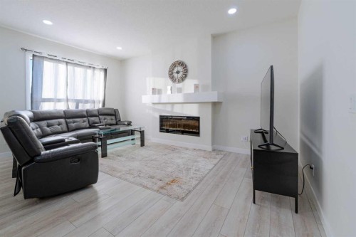 15 Midgrove Drive Sw, Airdrie, AB - Indoor Photo Showing Living Room With Fireplace