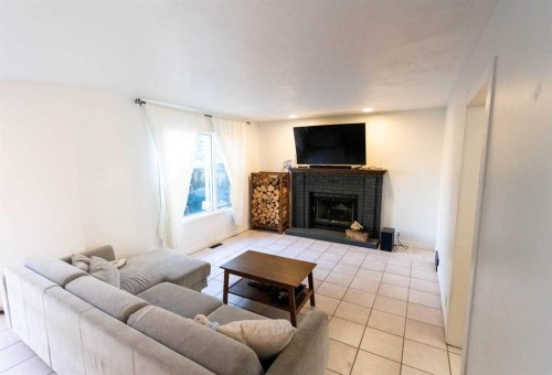 33 Sundown Close Se, Calgary, AB - Indoor Photo Showing Living Room With Fireplace