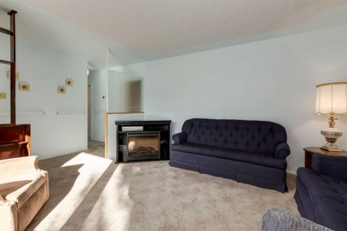 178 Windermere Road Sw, Calgary, AB - Indoor Photo Showing Living Room With Fireplace