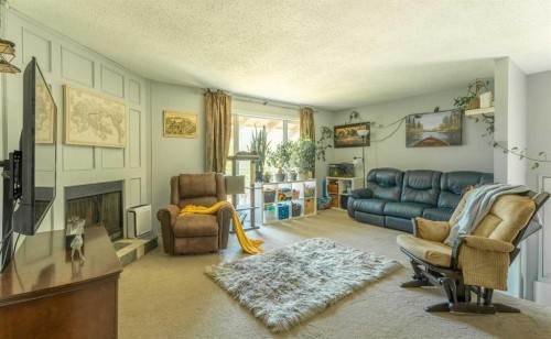 53 Beaconsfield Crescent Nw, Calgary, AB - Indoor Photo Showing Living Room With Fireplace