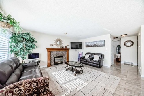 41 Covette Bay Ne, Calgary, AB - Indoor Photo Showing Living Room With Fireplace