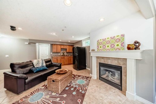 73 Crestmont Drive Sw, Calgary, AB - Indoor Photo Showing Living Room With Fireplace
