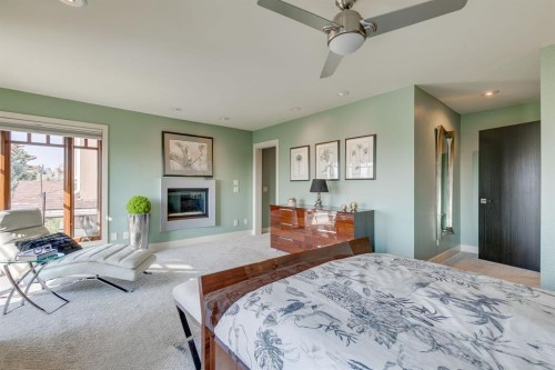 954 Drury Avenue Ne, Calgary, AB - Indoor Photo Showing Bedroom With Fireplace