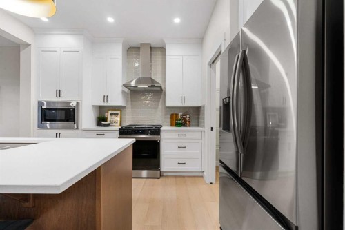 128 Versant Point Sw, Calgary, AB - Indoor Photo Showing Kitchen With Upgraded Kitchen