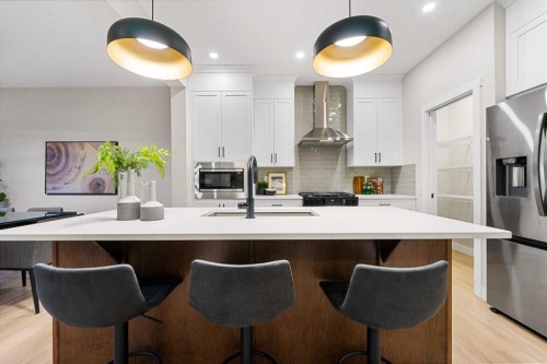 128 Versant Point Sw, Calgary, AB - Indoor Photo Showing Kitchen With Upgraded Kitchen