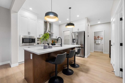 128 Versant Point Sw, Calgary, AB - Indoor Photo Showing Kitchen With Upgraded Kitchen