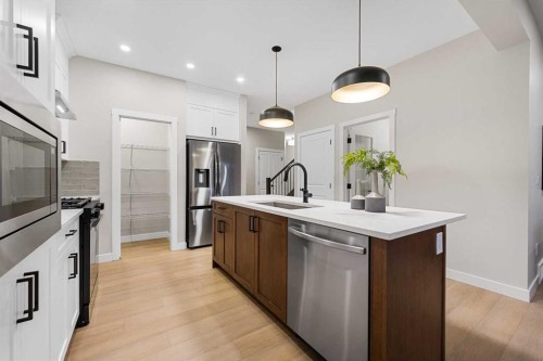 128 Versant Point Sw, Calgary, AB - Indoor Photo Showing Kitchen With Stainless Steel Kitchen With Upgraded Kitchen