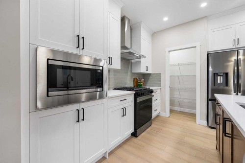 128 Versant Point Sw, Calgary, AB - Indoor Photo Showing Kitchen With Upgraded Kitchen