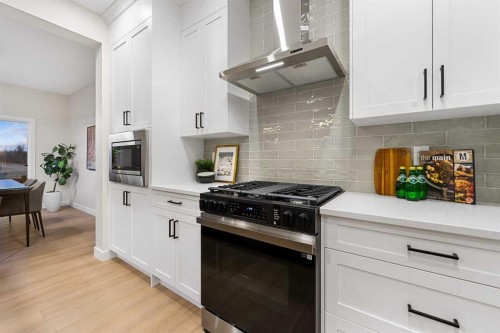 128 Versant Point Sw, Calgary, AB - Indoor Photo Showing Kitchen With Upgraded Kitchen