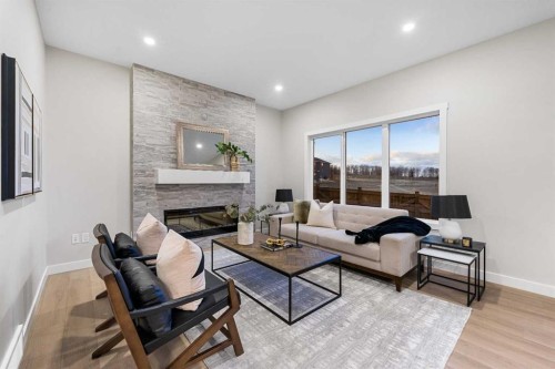 128 Versant Point Sw, Calgary, AB - Indoor Photo Showing Living Room With Fireplace