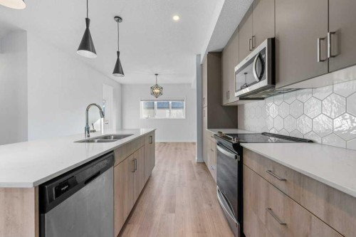 64 Creekside Boulevard Sw, Calgary, AB - Indoor Photo Showing Kitchen With Double Sink With Upgraded Kitchen