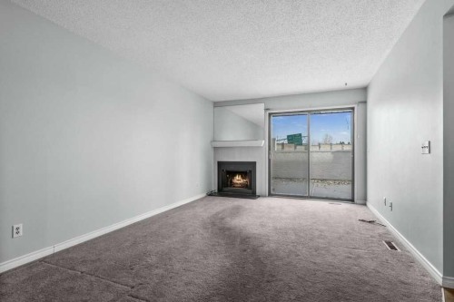 105-3500 Varsity Drive Nw, Calgary, AB - Indoor With Fireplace