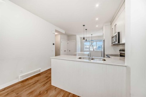 301-50 Cornerstone Passage, Calgary, AB - Indoor Photo Showing Kitchen With Double Sink