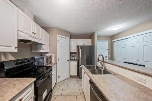 117-260 Shawville Way Se, Calgary, AB - Indoor Photo Showing Kitchen With Double Sink