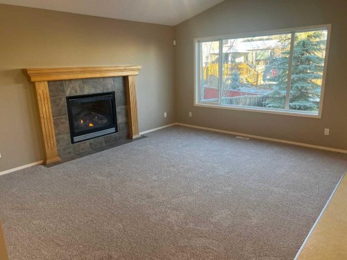 40 Bridlewood Gardens Sw, Calgary, AB - Indoor Photo Showing Living Room With Fireplace