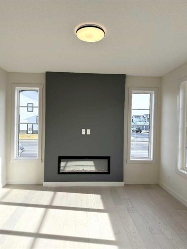 220 Waterford Heath, Chestermere, AB - Indoor Photo Showing Living Room With Fireplace