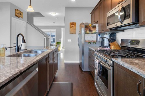 82 Fireside Cove, Cochrane, AB - Indoor Photo Showing Kitchen With Double Sink With Upgraded Kitchen