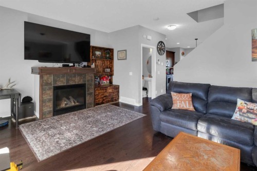 82 Fireside Cove, Cochrane, AB - Indoor Photo Showing Living Room With Fireplace