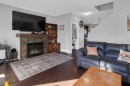 82 Fireside Cove, Cochrane, AB  - Indoor Photo Showing Living Room With Fireplace 