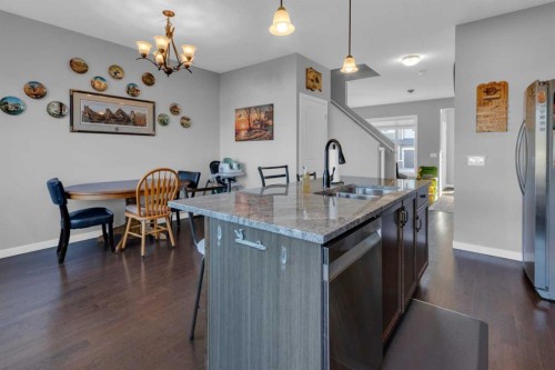 82 Fireside Cove, Cochrane, AB - Indoor Photo Showing Kitchen With Double Sink With Upgraded Kitchen