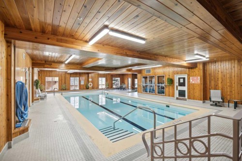 338-8535 Bonaventure Drive Se, Calgary, AB - Indoor Photo Showing Other Room With In Ground Pool