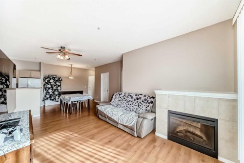 2115-1140 Taradale Drive Ne, Calgary, AB - Indoor Photo Showing Living Room With Fireplace