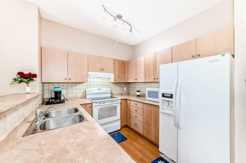 2115-1140 Taradale Drive Ne, Calgary, AB - Indoor Photo Showing Kitchen With Double Sink