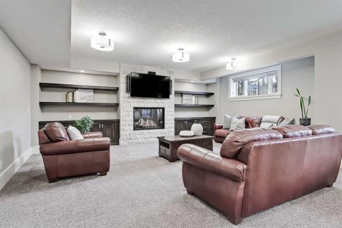 32 Aspen Ridge Manor Sw, Calgary, AB - Indoor Photo Showing Living Room With Fireplace