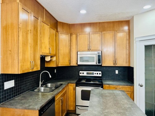 8 Taralake Way Ne, Calgary, AB - Indoor Photo Showing Kitchen With Stainless Steel Kitchen With Double Sink