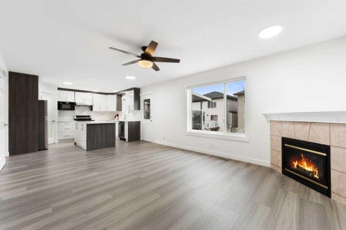115 Taracove Landing Ne, Calgary, AB - Indoor Photo Showing Living Room With Fireplace