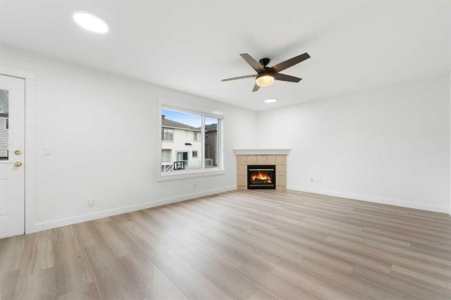 115 Taracove Landing Ne, Calgary, AB - Indoor With Fireplace