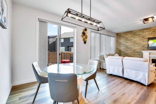 353 Walcrest View Se, Calgary, AB - Indoor Photo Showing Dining Room With Fireplace