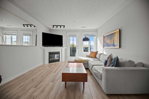 304-1608 12 Avenue Sw, Calgary, AB - Indoor Photo Showing Living Room With Fireplace