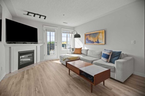304-1608 12 Avenue Sw, Calgary, AB - Indoor Photo Showing Living Room With Fireplace