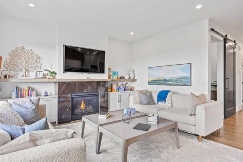 656 Bayview Way Sw, Airdrie, AB - Indoor Photo Showing Living Room With Fireplace
