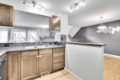 229 Luxstone Way Sw, Airdrie, AB - Indoor Photo Showing Kitchen With Double Sink