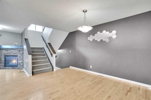 229 Luxstone Way Sw, Airdrie, AB - Indoor With Fireplace