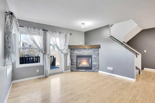 229 Luxstone Way Sw, Airdrie, AB - Indoor Photo Showing Living Room With Fireplace