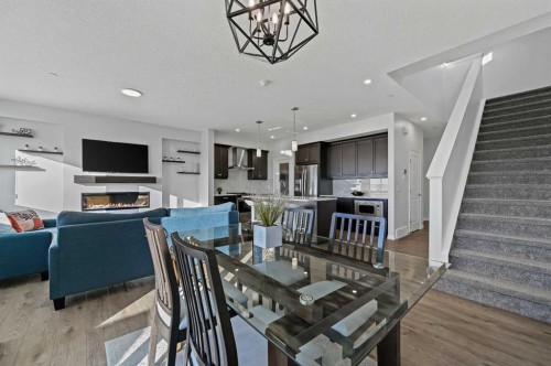 126 Howse Common Ne, Calgary, AB - Indoor Photo Showing Dining Room With Fireplace