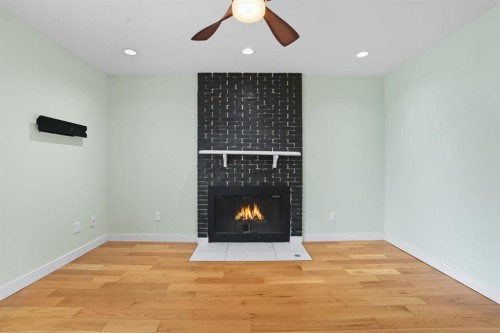 108 Falchurch Crescent Ne, Calgary, AB - Indoor Photo Showing Other Room With Fireplace