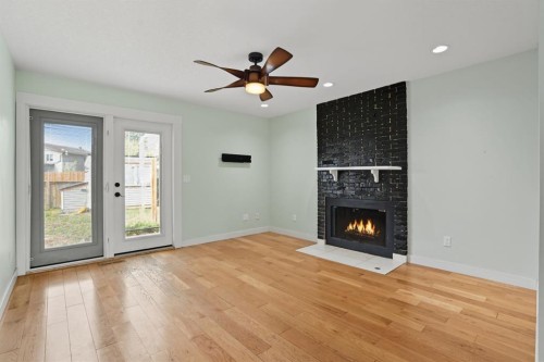 108 Falchurch Crescent Ne, Calgary, AB - Indoor Photo Showing Living Room With Fireplace