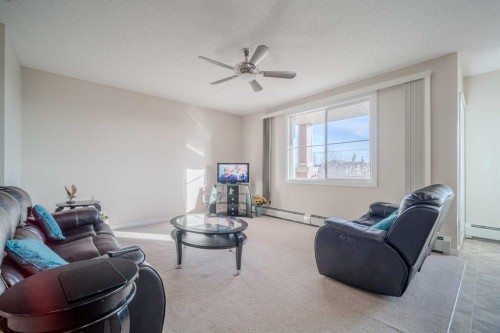 1202-2370 Bayside Road Sw, Airdrie, AB - Indoor Photo Showing Living Room